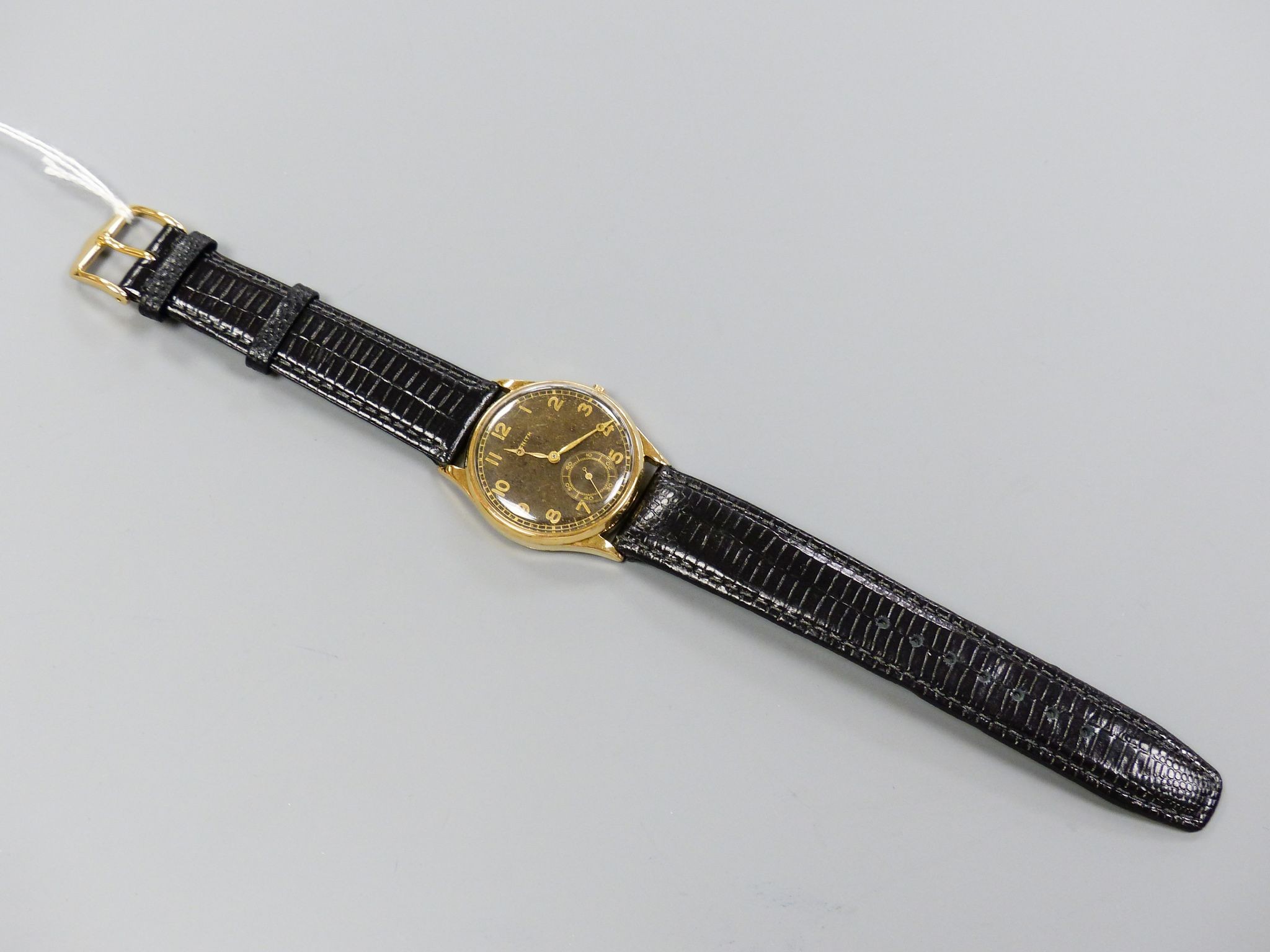 A gentleman's 14k yellow metal Zenith manual wind wrist watch, with subsidiary seconds, on later strap, winding crown loose but present